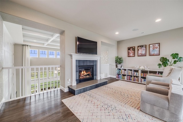 8750 Red Primrose St, Franktown, CO 80116 - living room with wood finished floors, beamed ceiling, baseboards, recessed lighting, and a tile fireplace