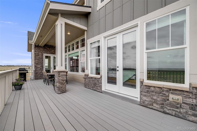 8750 Red Primrose St, Franktown, CO 80116 - wooden terrace with outdoor dining space, french doors, and a grill