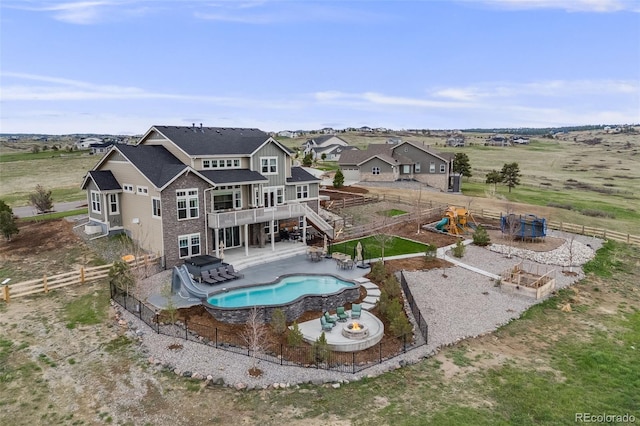 8750 Red Primrose St, Franktown, CO 80116 - back of property with a deck, a fenced in pool, a fenced backyard, a playground, and a jacuzzi