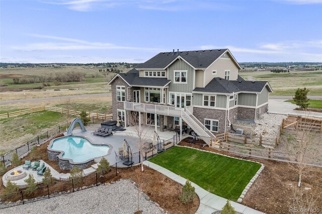 8750 Red Primrose St, Franktown, CO 80116 - rear view of property with a fenced backyard, a patio, and board and batten siding