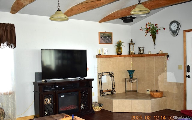 living room with a glass covered fireplace, beamed ceiling, and wood finished floors