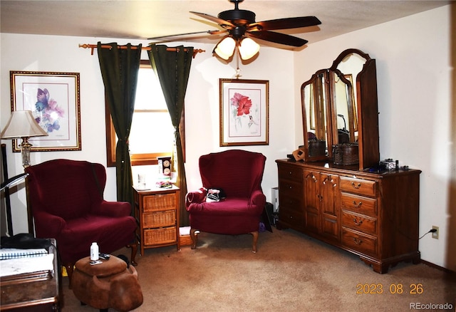 living area with carpet and a ceiling fan