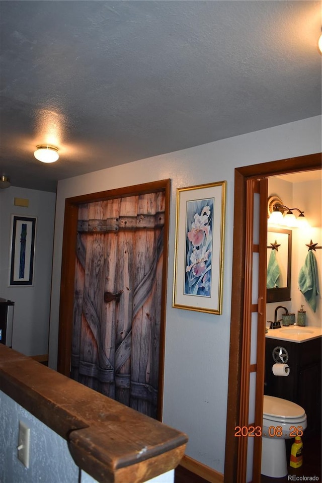 interior space with a textured ceiling and a sink