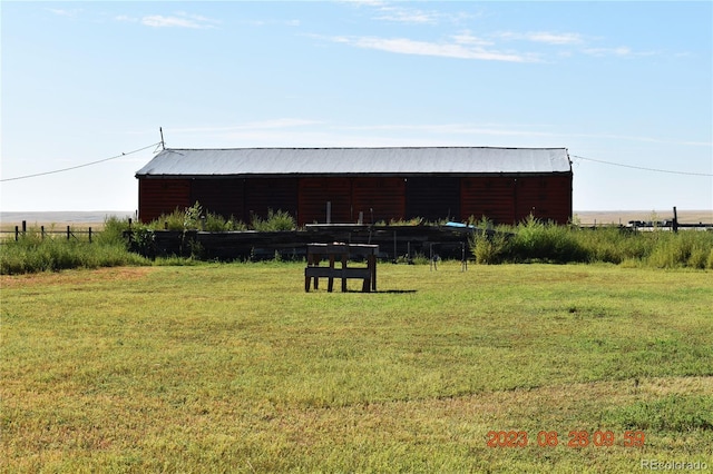 exterior space featuring a rural view and an outdoor structure