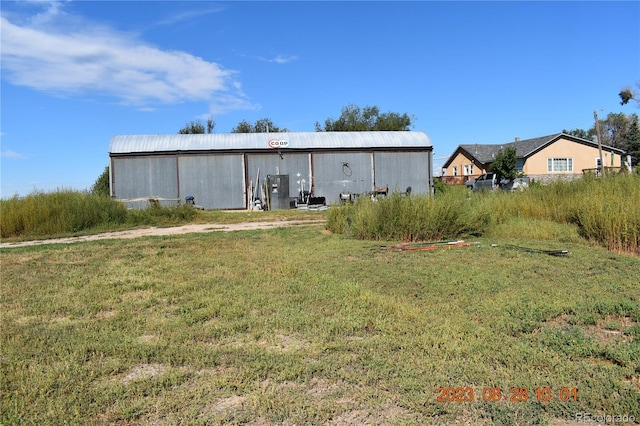 view of yard featuring an outbuilding and an outdoor structure