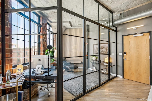 interior space featuring hardwood / wood-style flooring, lofted ceiling, and floor to ceiling windows