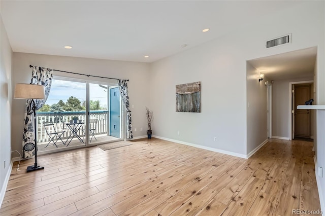 spare room featuring light wood-style floors, baseboards, and recessed lighting