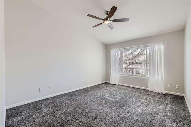 spare room featuring carpet flooring, vaulted ceiling, baseboards, and a ceiling fan