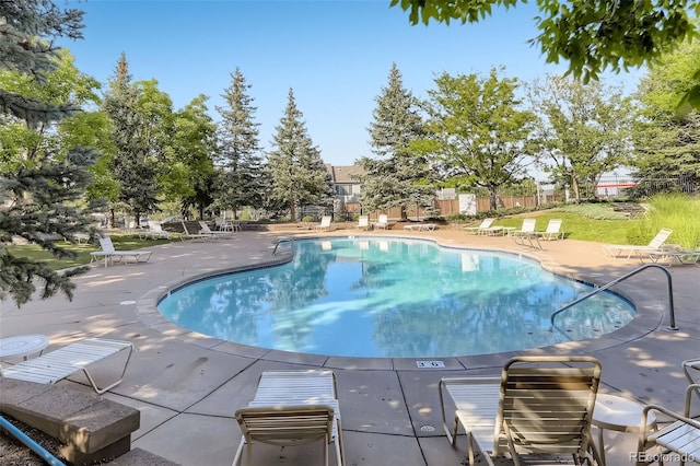 community pool featuring a patio area and fence