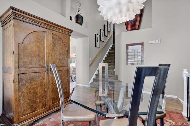 18153 E Amherst Dr, Aurora, CO 80013 - dining space with a chandelier, stairway, and a high ceiling