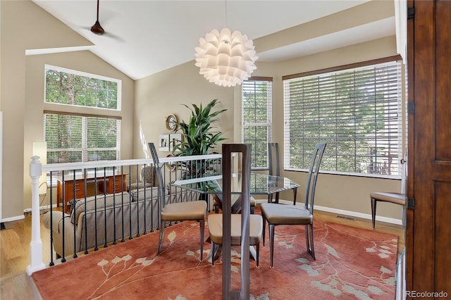 18153 E Amherst Dr, Aurora, CO 80013 - dining space with healthy amount of natural light, wood finished floors, and vaulted ceiling