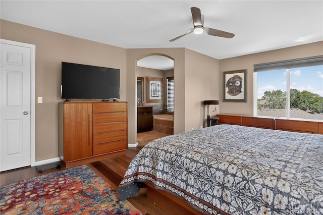 18153 E Amherst Dr, Aurora, CO 80013 - bedroom featuring wood finished floors, arched walkways, and ceiling fan