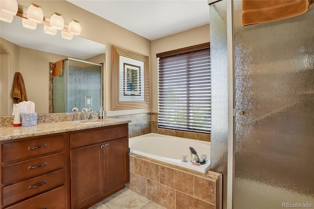 18153 E Amherst Dr, Aurora, CO 80013 - bathroom featuring vanity, a stall shower, a garden tub, and tile patterned floors