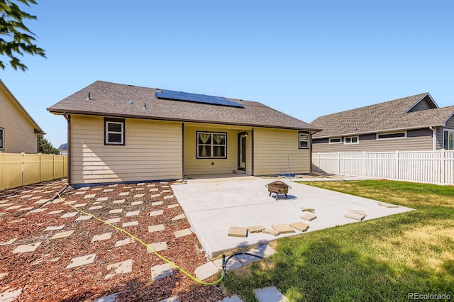 5770 Waverley Ave, Firestone, CO 80504 - back of house with an outdoor fire pit, a patio area, solar panels, and a fenced backyard