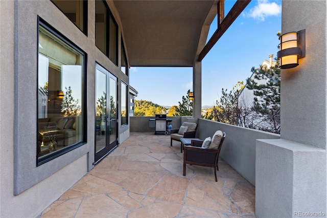 view of patio featuring a balcony