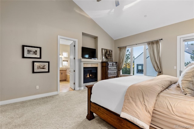 bedroom featuring access to outside, multiple windows, light carpet, and connected bathroom