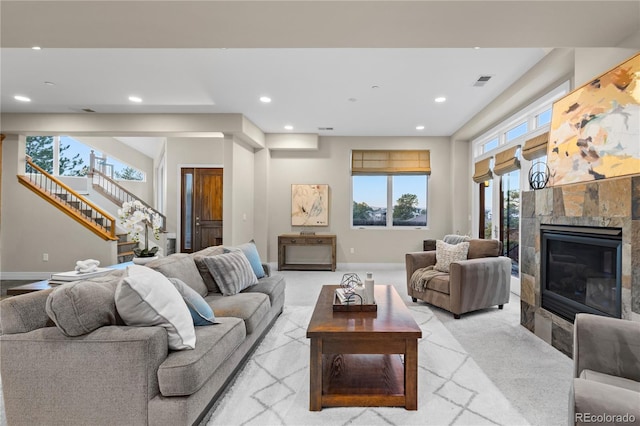 living room with light colored carpet and a fireplace