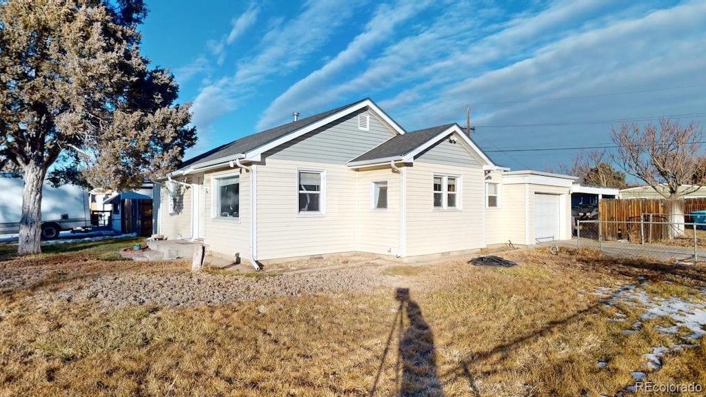 view of home's exterior featuring a lawn and a garage