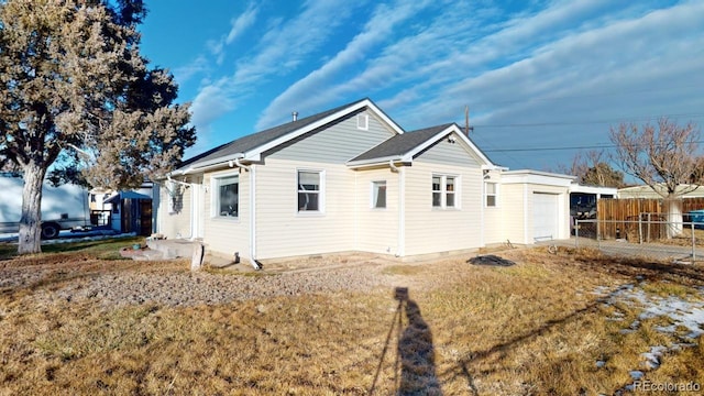 view of home's exterior featuring a lawn and a garage