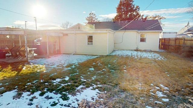 snow covered property featuring a yard