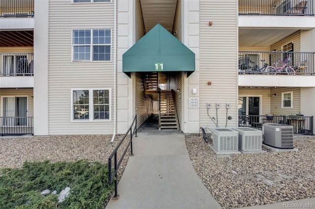 view of property with cooling unit and stairs