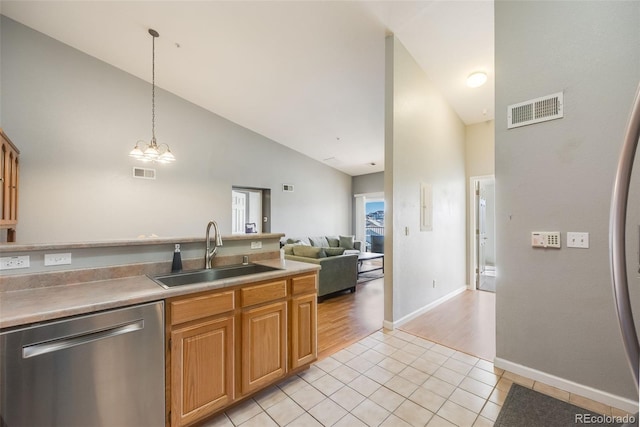 kitchen with stainless steel dishwasher, pendant lighting, visible vents, and a sink