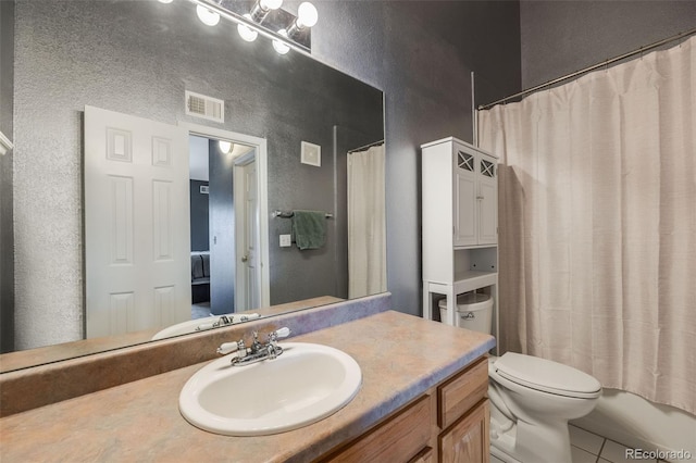 full bath featuring tile patterned flooring, visible vents, toilet, a textured wall, and vanity