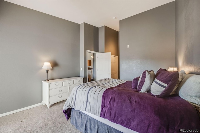 bedroom with baseboards and light carpet