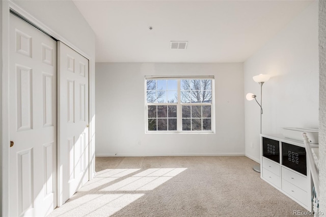 unfurnished bedroom featuring visible vents, carpet flooring, and baseboards