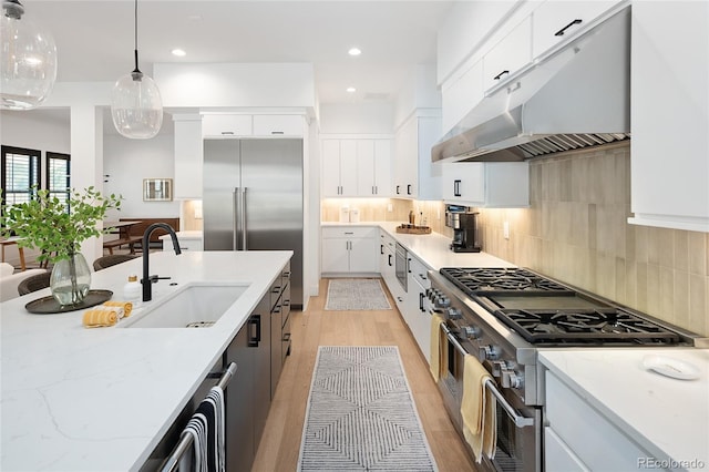 3149 W 35th Ave, Denver, CO 80211 - kitchen featuring under cabinet range hood, high quality appliances, pendant lighting, light stone counters, and backsplash