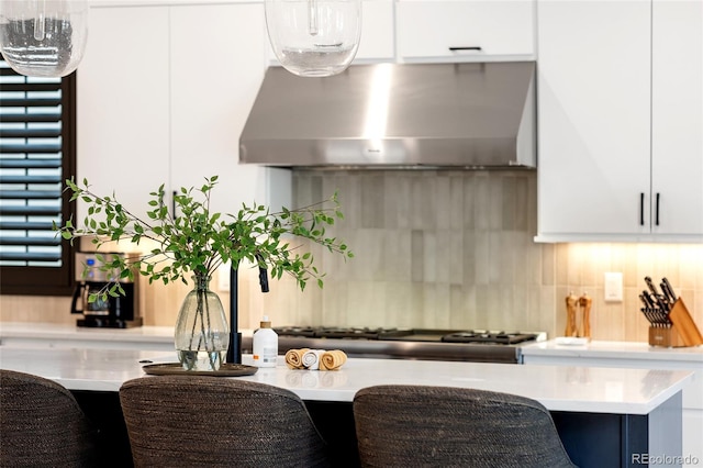 3149 W 35th Ave, Denver, CO 80211 - kitchen with extractor fan, light countertops, decorative backsplash, and white cabinets