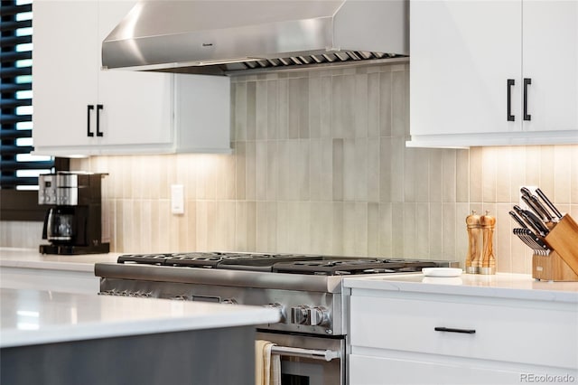 3149 W 35th Ave, Denver, CO 80211 - kitchen with stainless steel range, wall chimney exhaust hood, light countertops, white cabinetry, and backsplash