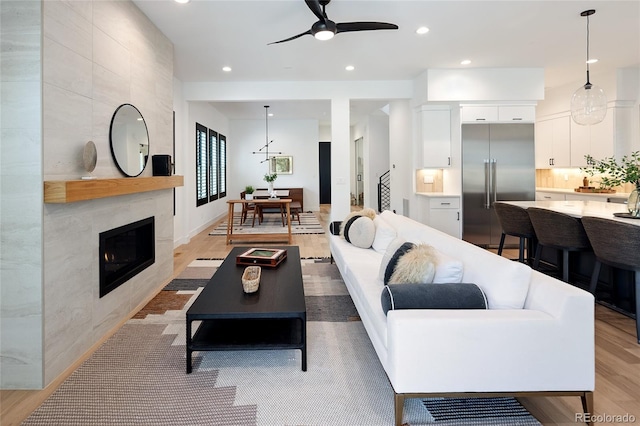 3149 W 35th Ave, Denver, CO 80211 - living area with a tile fireplace, a ceiling fan, light wood-type flooring, and recessed lighting