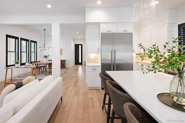 3149 W 35th Ave, Denver, CO 80211 - kitchen with modern cabinets, built in fridge, white cabinets, light wood-type flooring, and recessed lighting