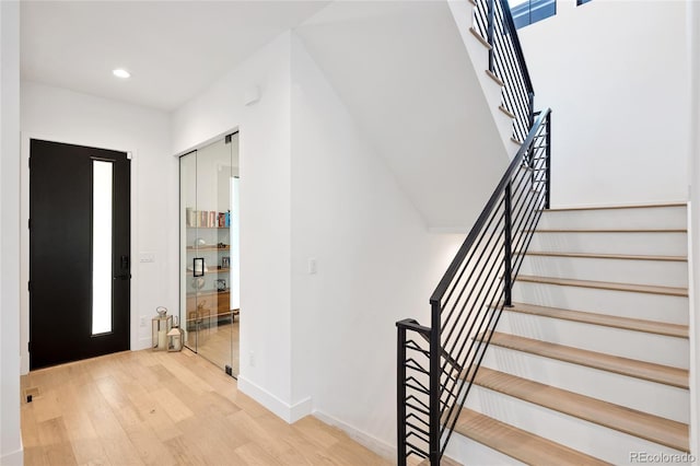 3149 W 35th Ave, Denver, CO 80211 - foyer entrance with light wood finished floors, stairs, and recessed lighting