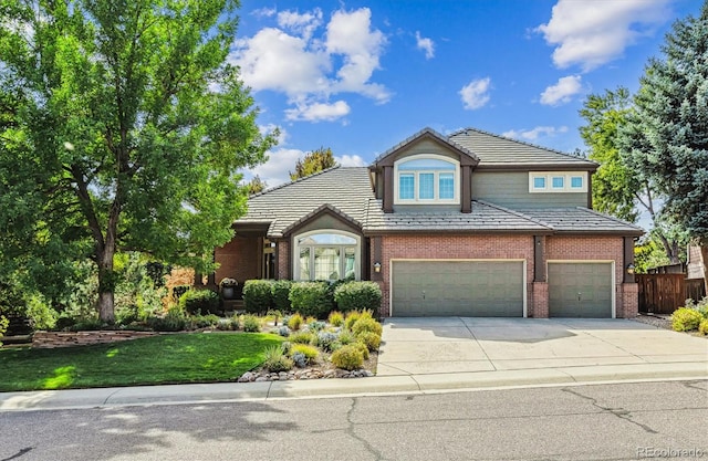 view of property with a front yard and a garage