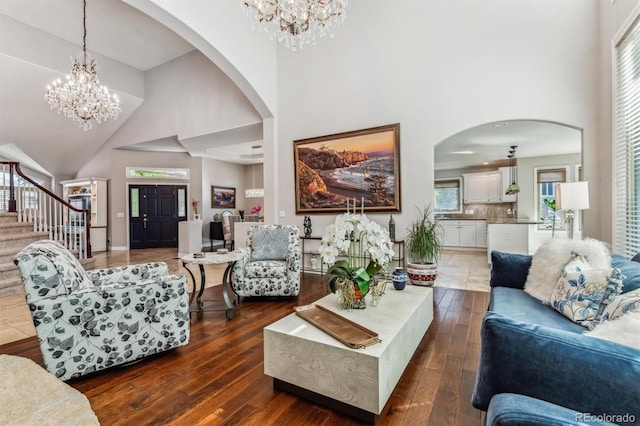 living room with dark wood-type flooring and high vaulted ceiling