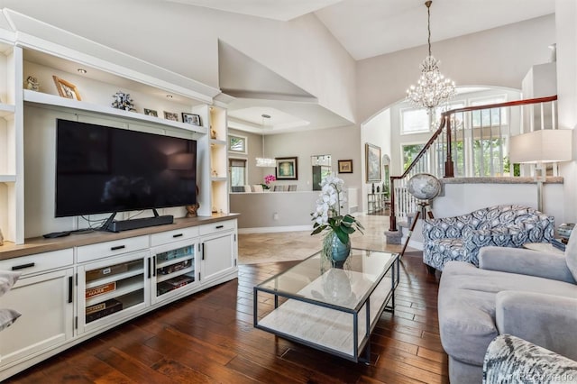 living room with lofted ceiling, a chandelier, and dark hardwood / wood-style flooring