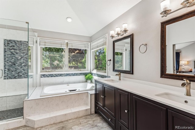 bathroom with wood-type flooring, vanity, lofted ceiling, and plus walk in shower