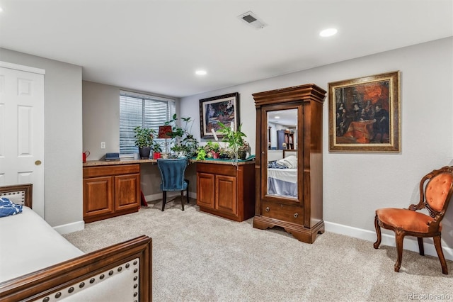 carpeted office featuring built in desk