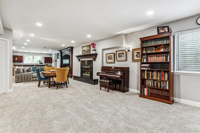 carpeted dining space featuring a fireplace