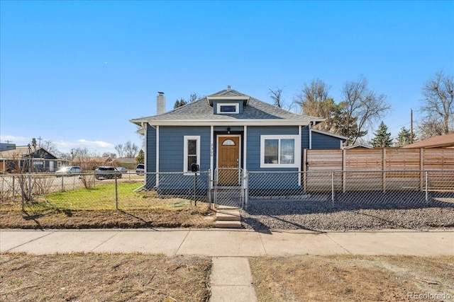 3300 W 2nd Ave, Denver, CO 80219 - view of front of home with a gate, a fenced front yard, a chimney, and a shingled roof