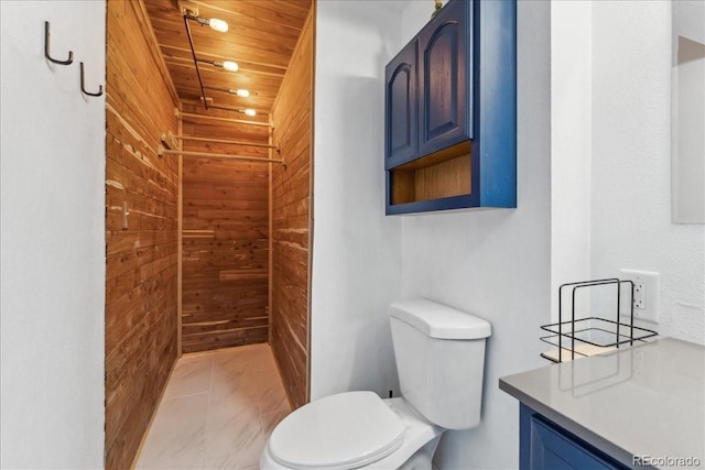 3300 W 2nd Ave, Denver, CO 80219 - bathroom with wooden walls, vanity, wooden ceiling, and marble finish floors