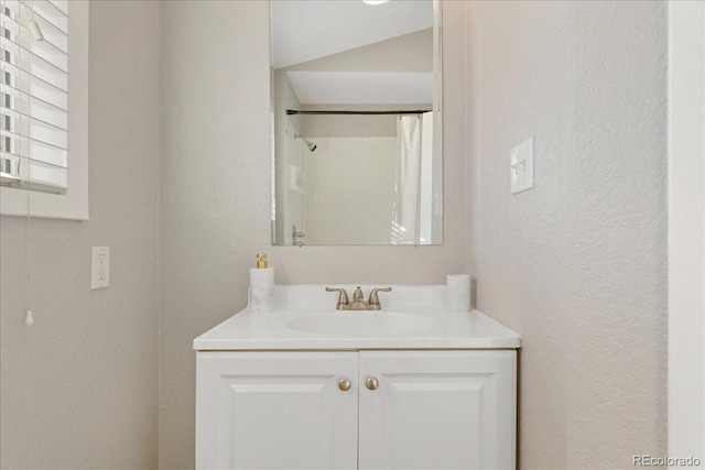 3300 W 2nd Ave, Denver, CO 80219 - full bathroom with vanity, a textured wall, and a shower with curtain