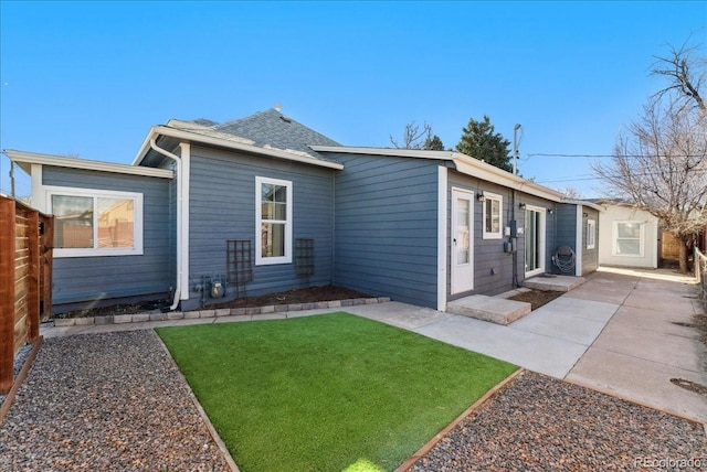 3300 W 2nd Ave, Denver, CO 80219 - rear view of house with a patio and roof with shingles