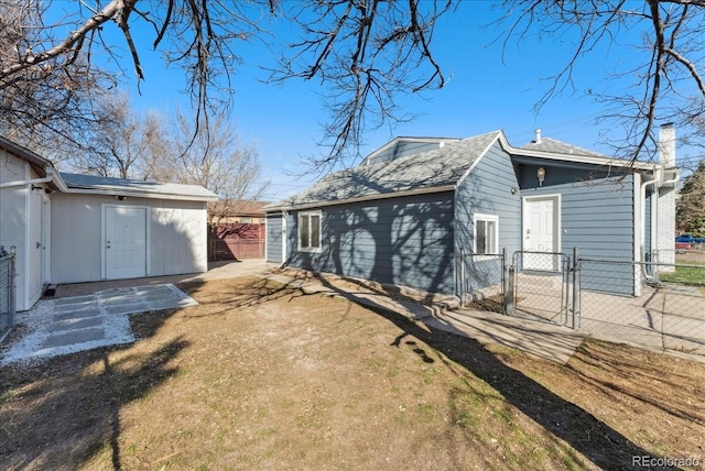 3300 W 2nd Ave, Denver, CO 80219 - rear view of property featuring a gate and a chimney