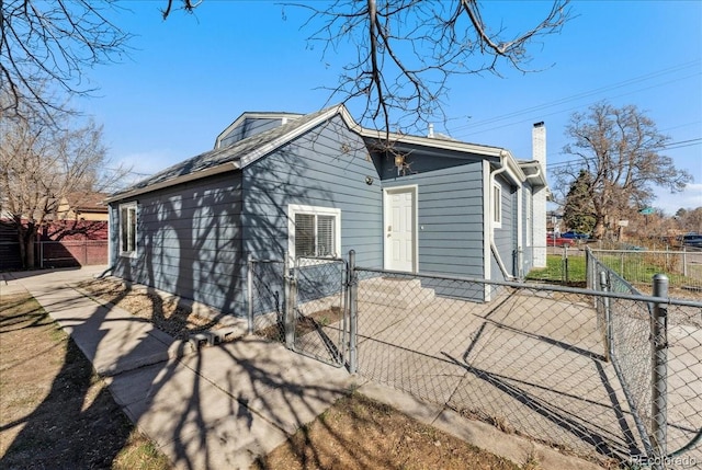 3300 W 2nd Ave, Denver, CO 80219 - rear view of house with a gate and a chimney