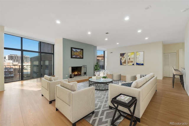 living room featuring light hardwood / wood-style floors and floor to ceiling windows