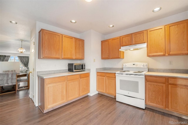 kitchen with light brown cabinets, light wood-type flooring, and white range with electric cooktop