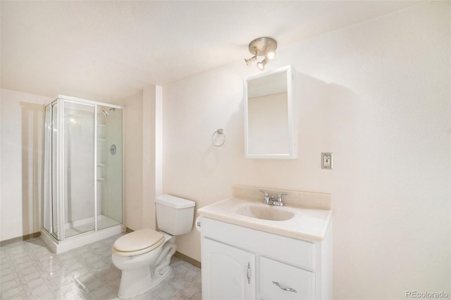 bathroom with walk in shower, vanity, and toilet